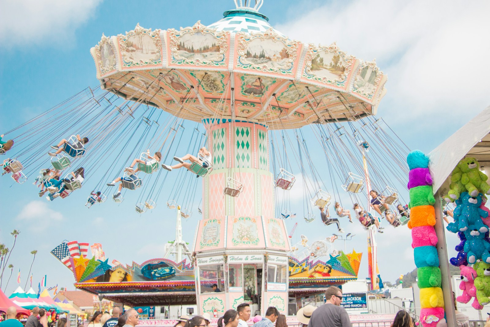 Visitors riding a swing attraction at a theme park